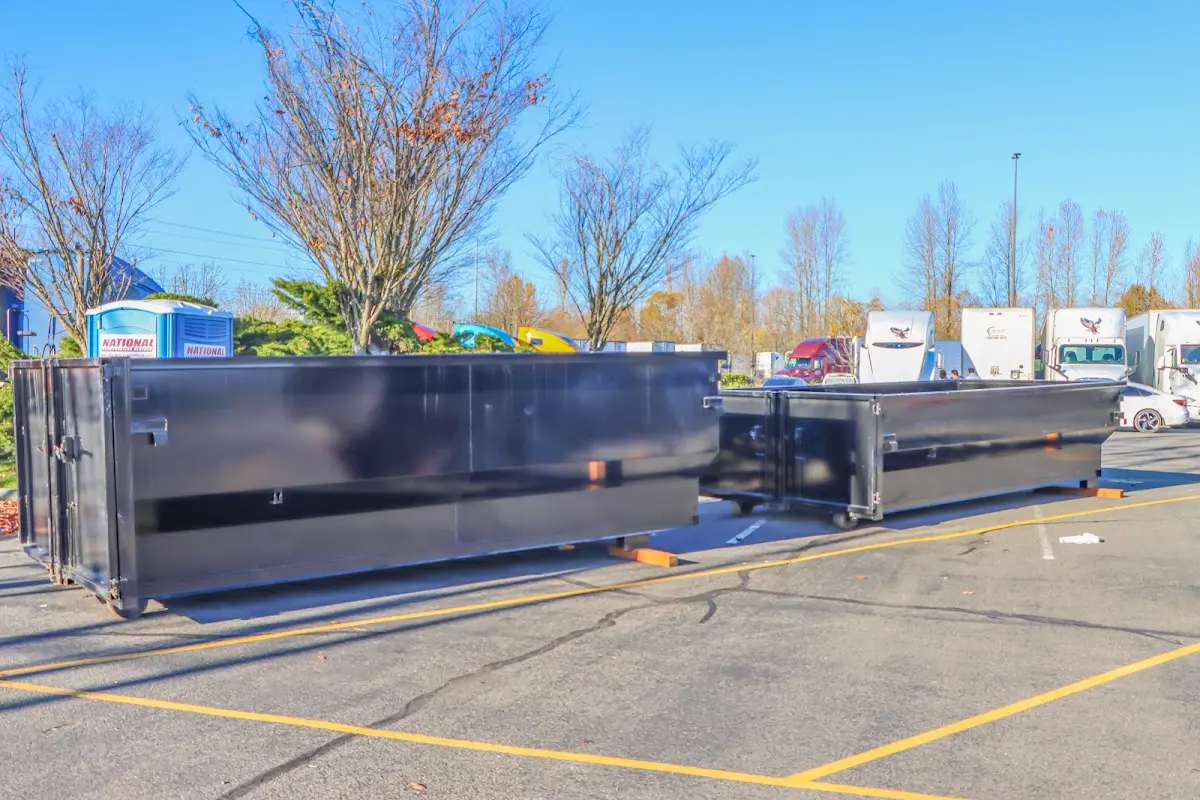 Professional dumpster rental service with roll-off container on residential driveway in Fort Washington